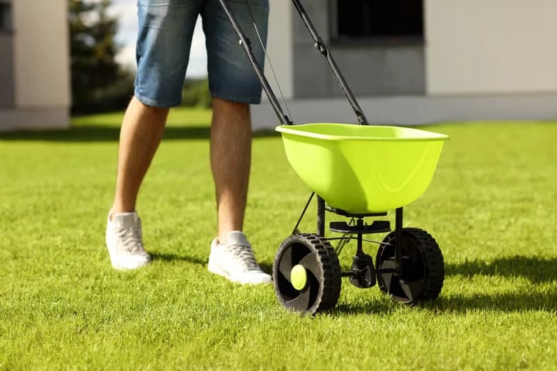 Crew treating lawn soil — interim stand-in until core-aeration photo ships